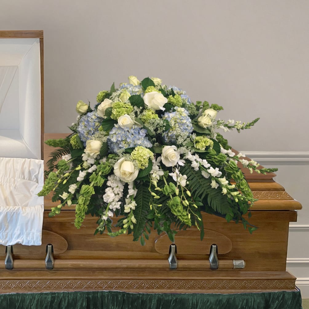 This beautiful cool colored casket blanket for a Funeral Home features white