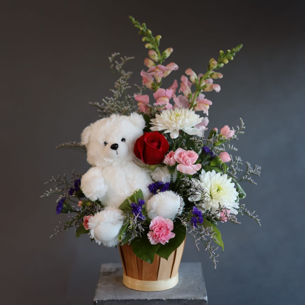 A very beary loveable arrangement with a small soft teddy plushie tucked