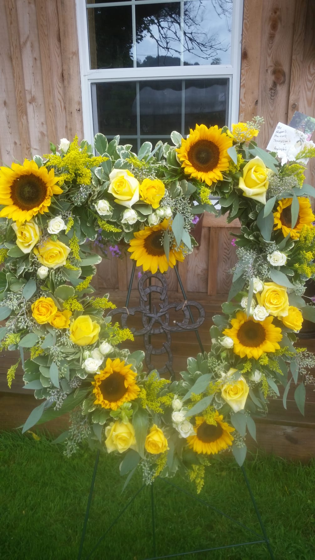 A beautiful heart filled with cheerful sunflowers, carnations, roses and seeded eucalyptus.