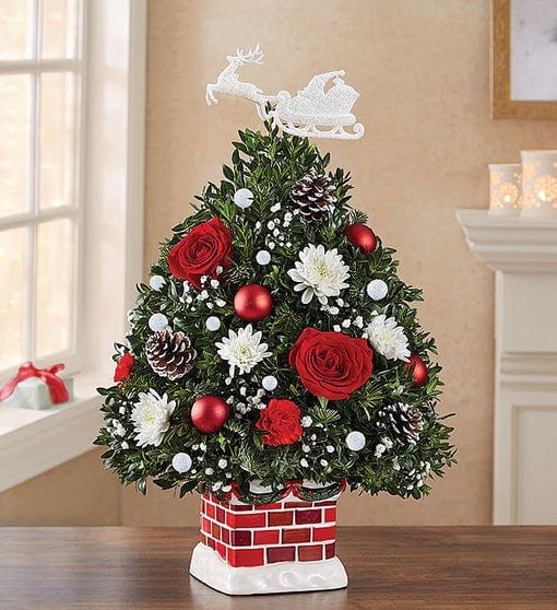 Round tree-shaped arrangement with red roses and mini carnations, white cushion poms