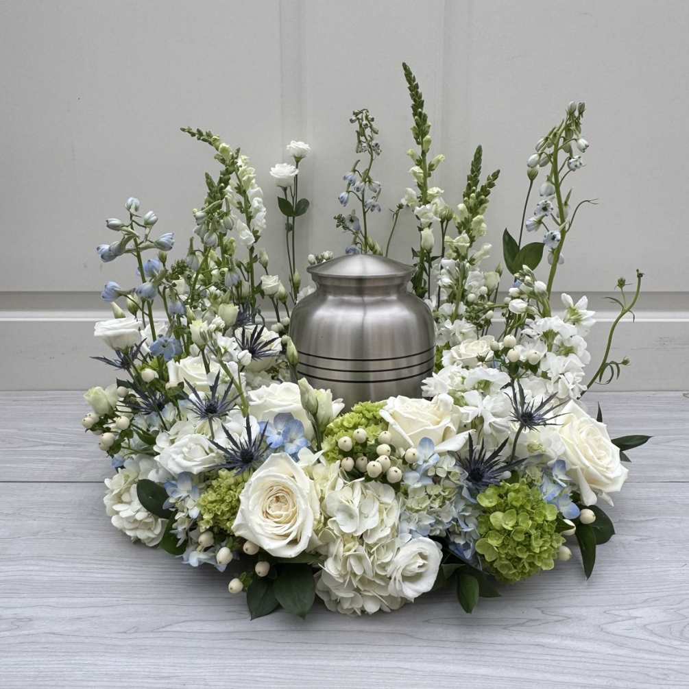 Shades of white, blue and green blooms including hydrangea, roses, delphinium and