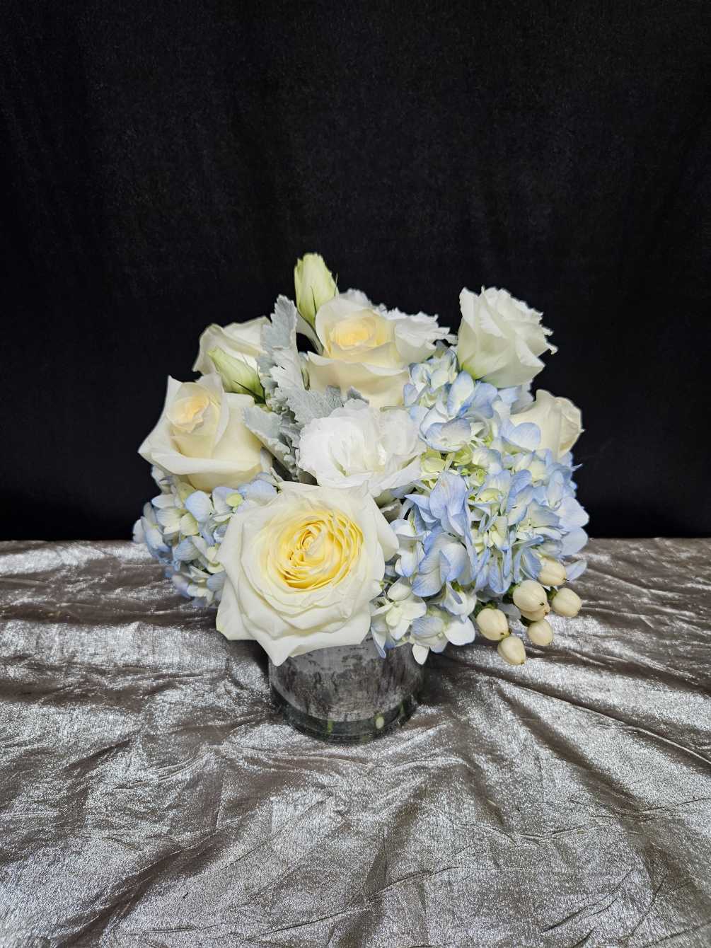 a clean arrangement utilizing blue hydrangeas with white flowers.
perfect for any occasion.