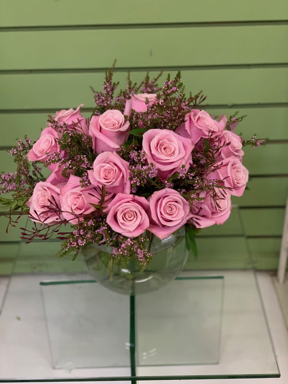 Long stemmed roses in a classic European hand-tied bouquet accented with foliage