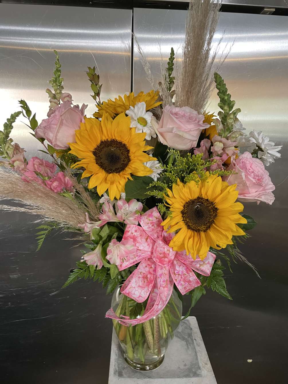 Sunflowers ,and premium pink garden roses with snaps, daisys and pampass grass