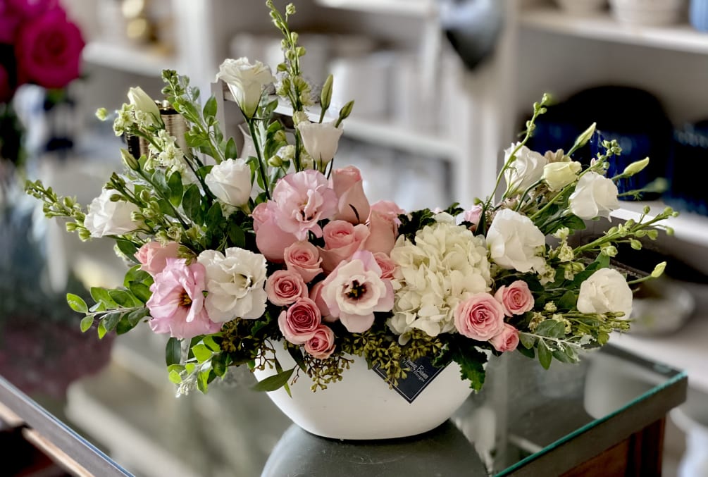 The Savannah Arrangement is filed with light pink roses, spray roses, lisianthus