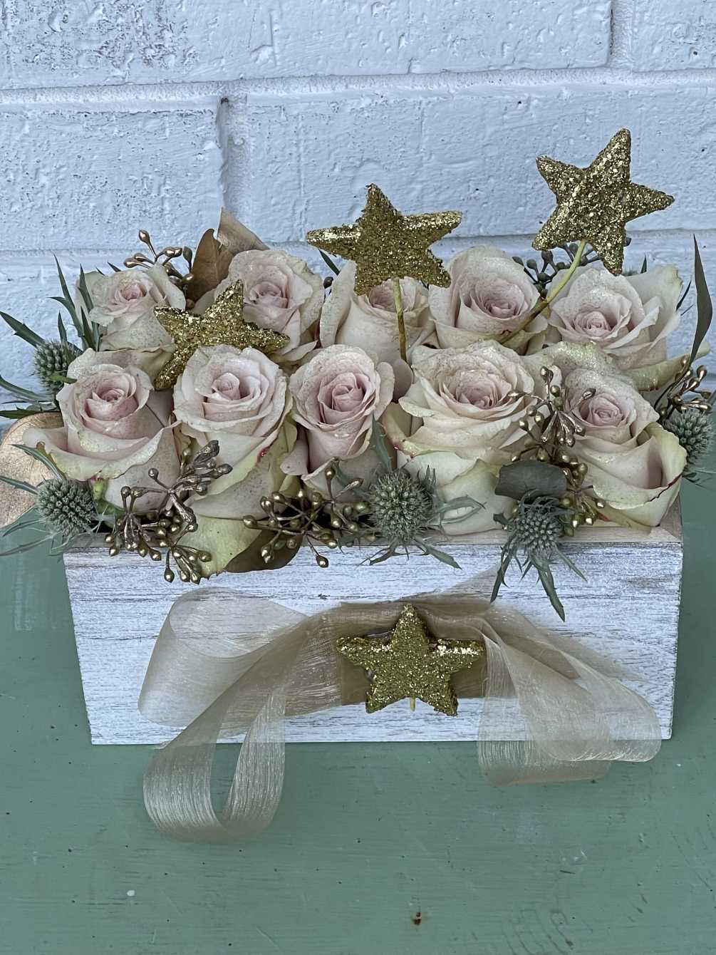 Our beautiful pink rose box is paired with beautiful gold accessories to