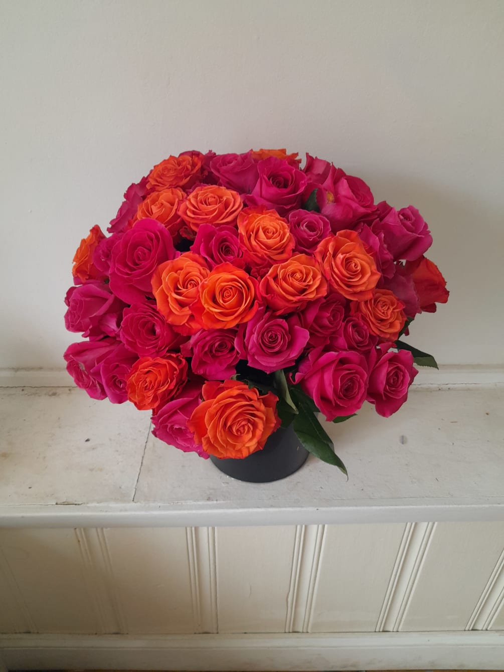 Beautiful hot pink Pink Floid roses mixed with some orange roses in