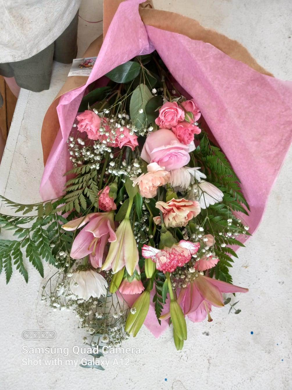 Variety of all pink flowers including roses, tulips, carnations, Larkspur and lilies