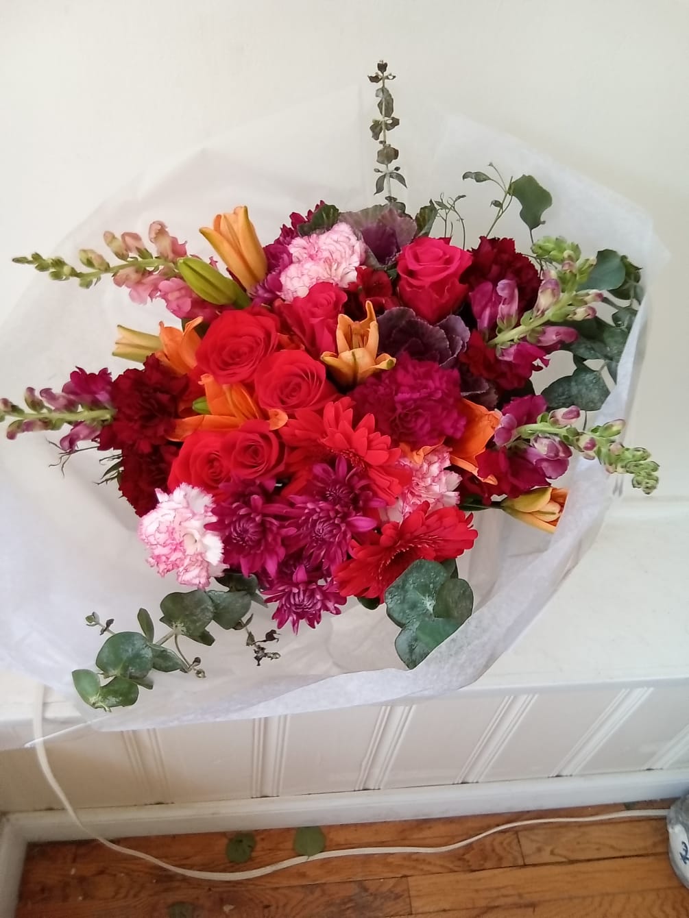 Vibrant red mix of roses, carnations and other flowers wrap