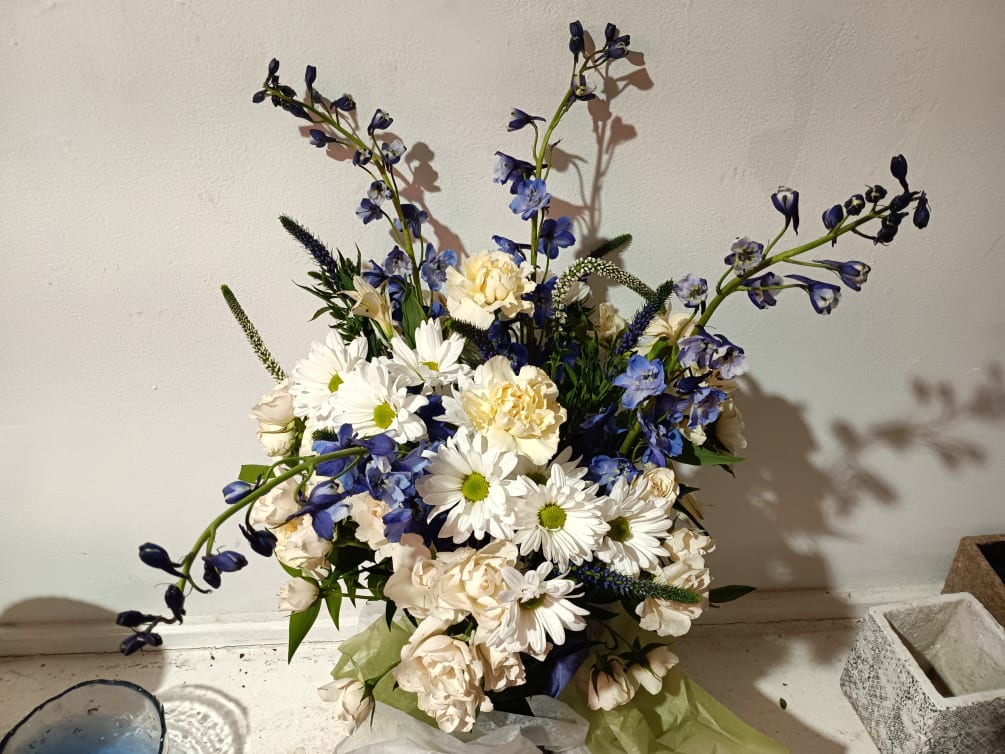 Beautiful pearl white daisies, spray or standard white roses, white veronica, blue