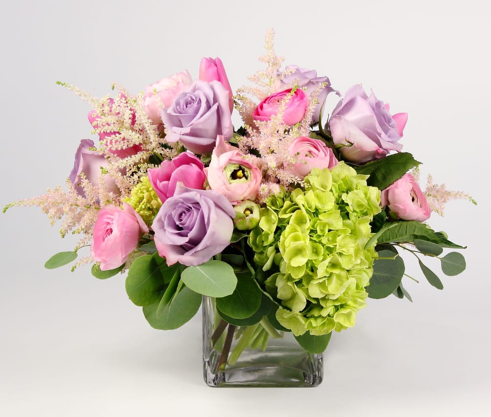 A low and lush compilation of Hydrangea, Roses and Ranunculus this vase