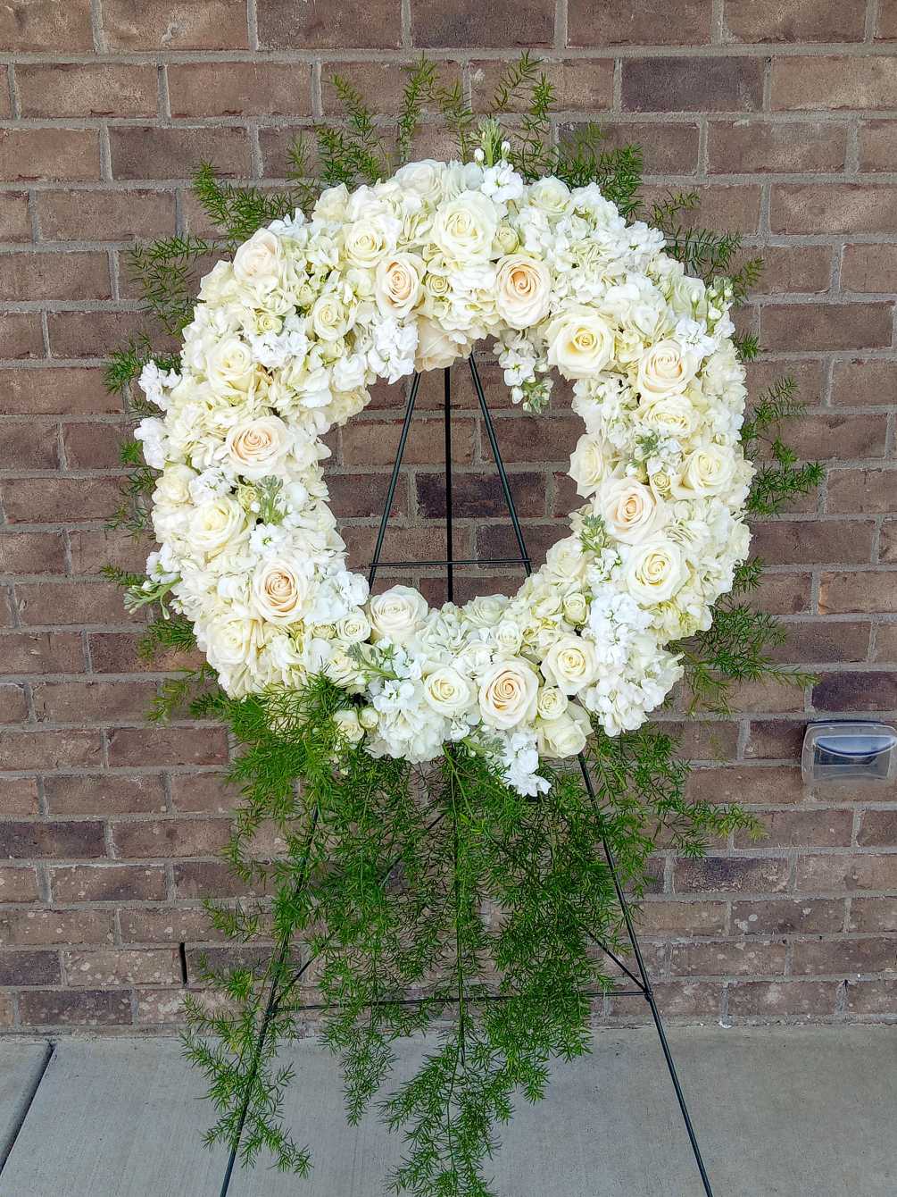 A beautiful round wreath of roses and hydrangeas.