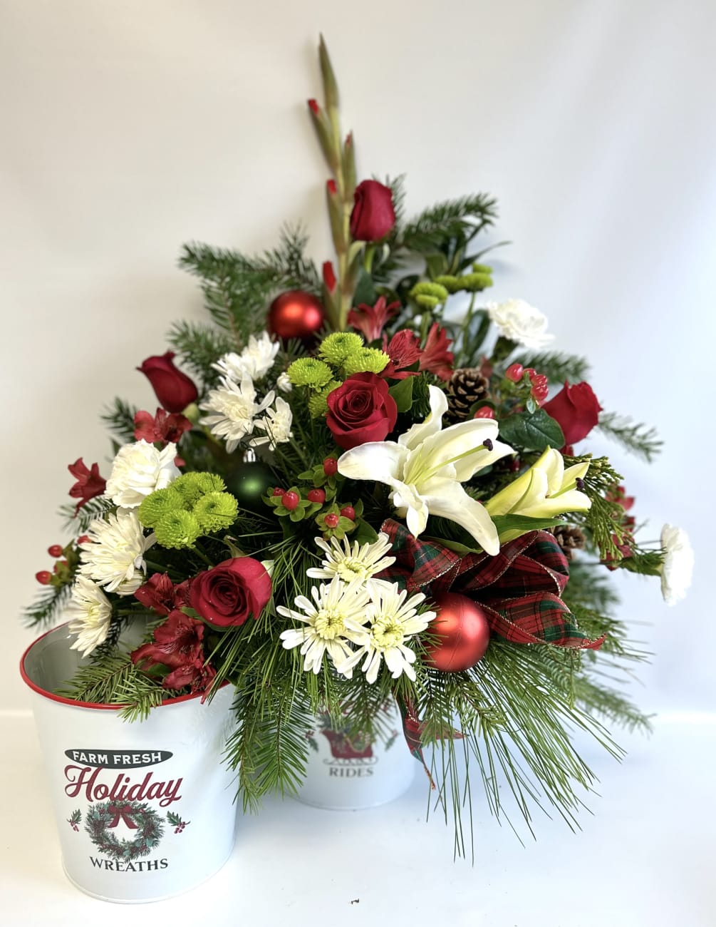 This large 6&rdquo; Metal Container is filled with flowers, Cones and Irnaments.