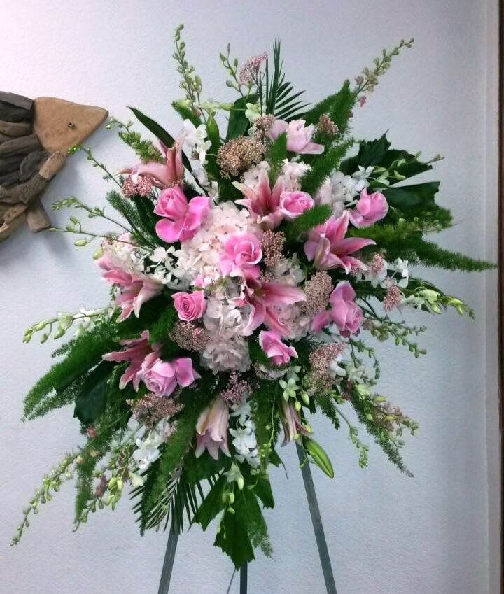 This standing spray consists of pink hydrangeas, pink roses, pink lilies, larkspur