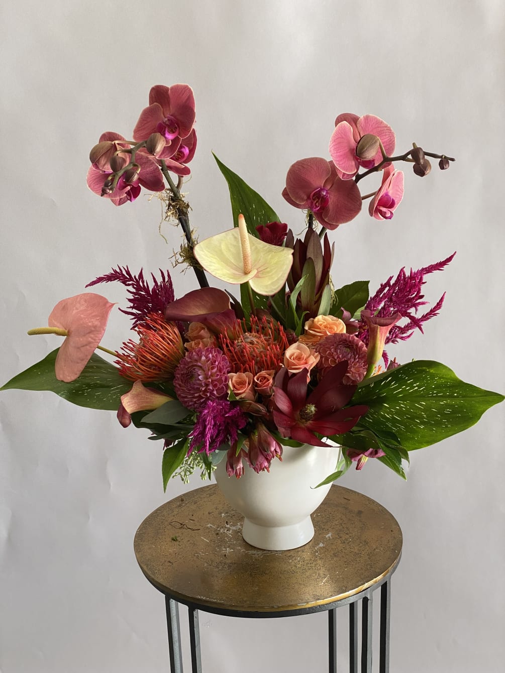 This tall showstopper features so many wonderful tropical blooms. Arrangement might change