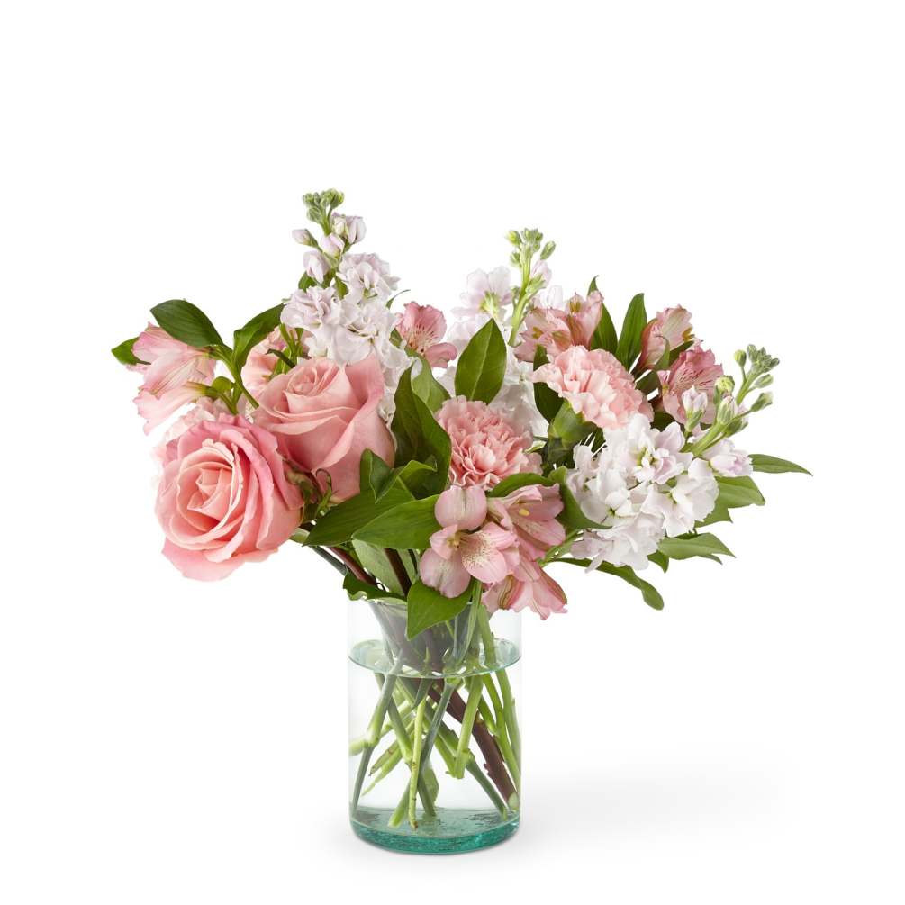 A rosy bouquet of roses, stock, carnations, and alstromeria arranged in a
