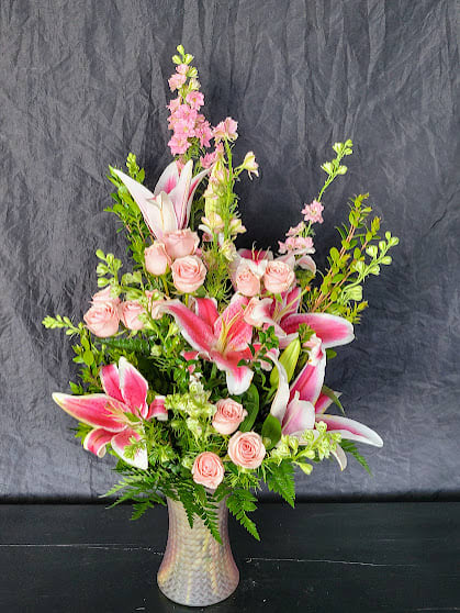 This arrangement is a pretty mix of pink spray roses and lilies.