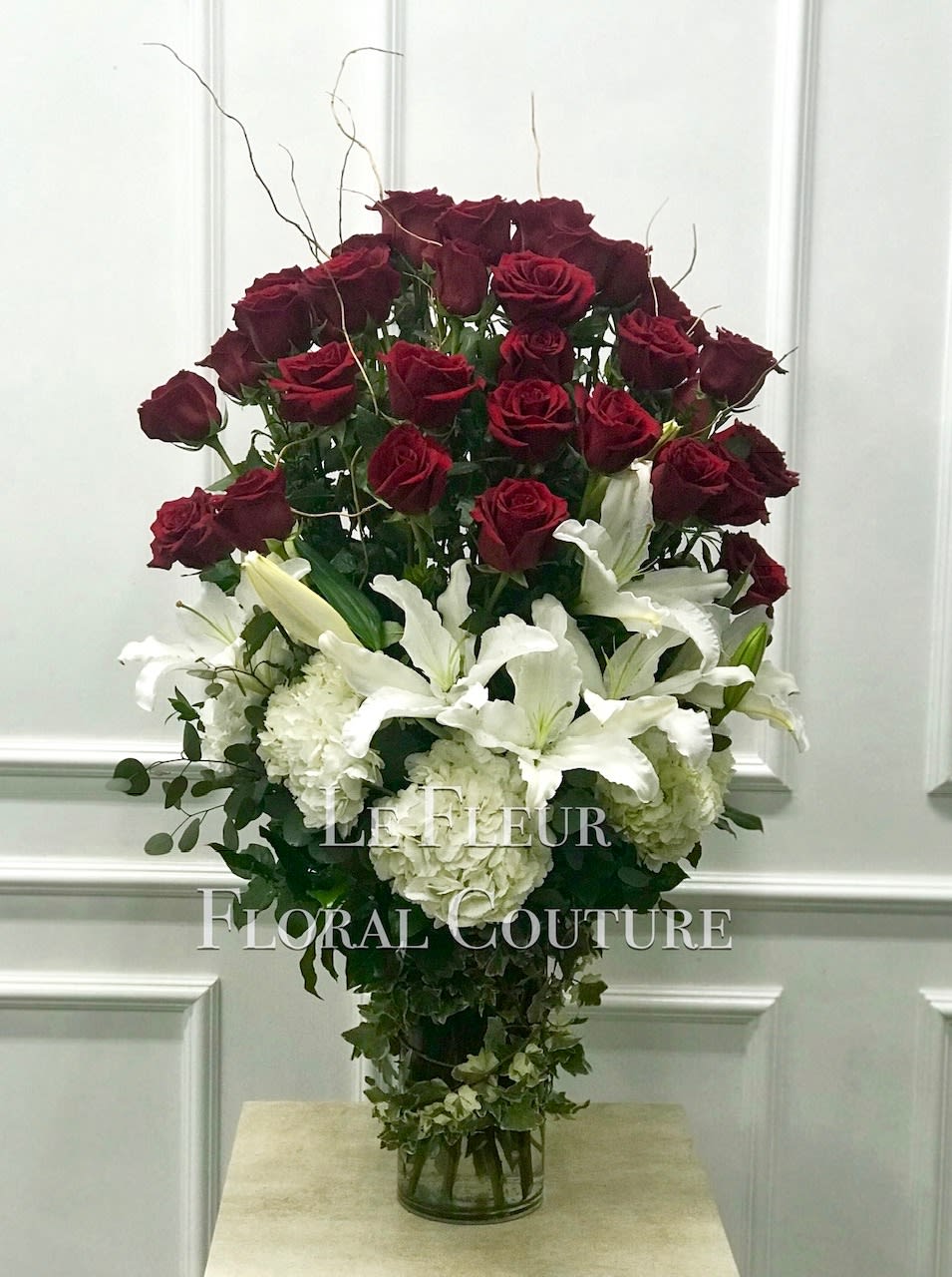 A beautiful and towering floral arrangement filled with three dozen red roses