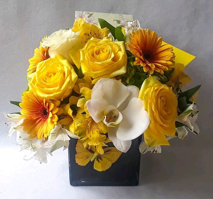 Beautiful yellow blossoms of that day roses orchids and the like arranged