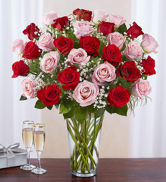Red, pink and hot pink roses with baby&#039;s breath and greenery 