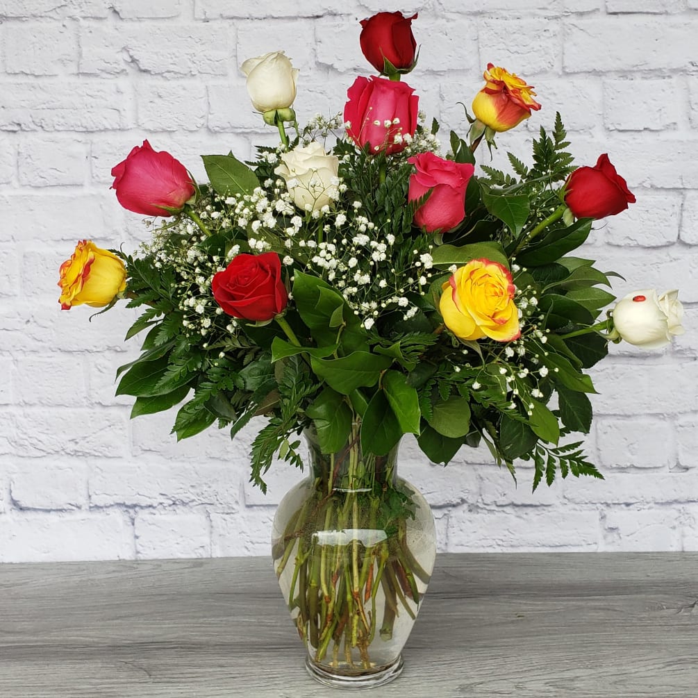These dozen mixed colored roses with baby&#039;s breath are a modern must!