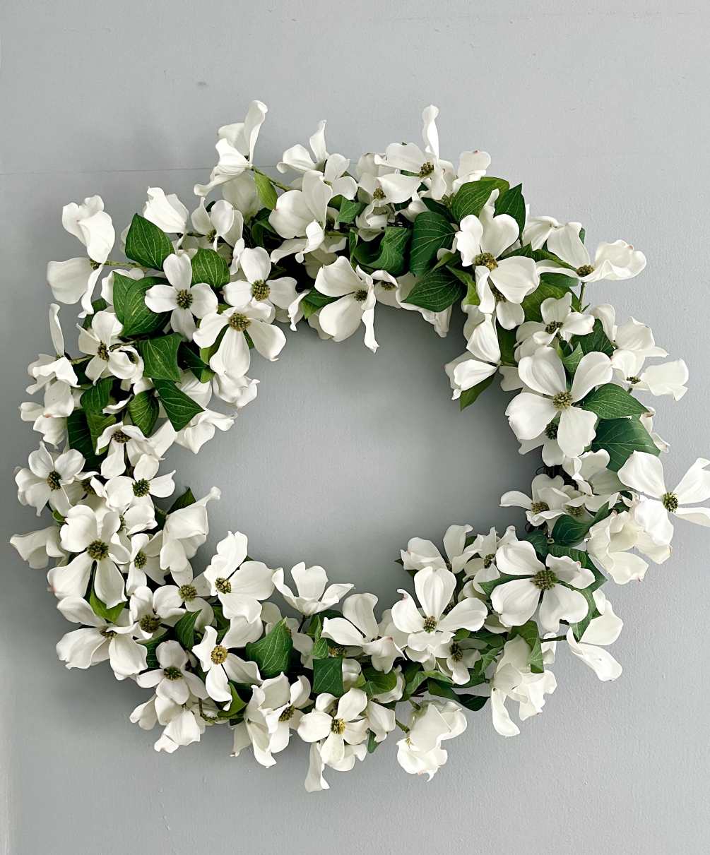 A beautiful all white wreath made of artificial flowers so you can