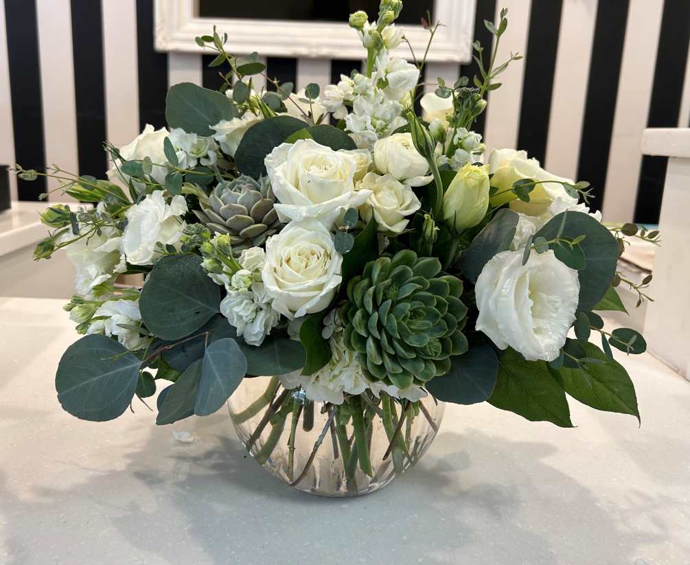 This Elegant arrangement includes premium blooms with Succulents in a bubble bowl