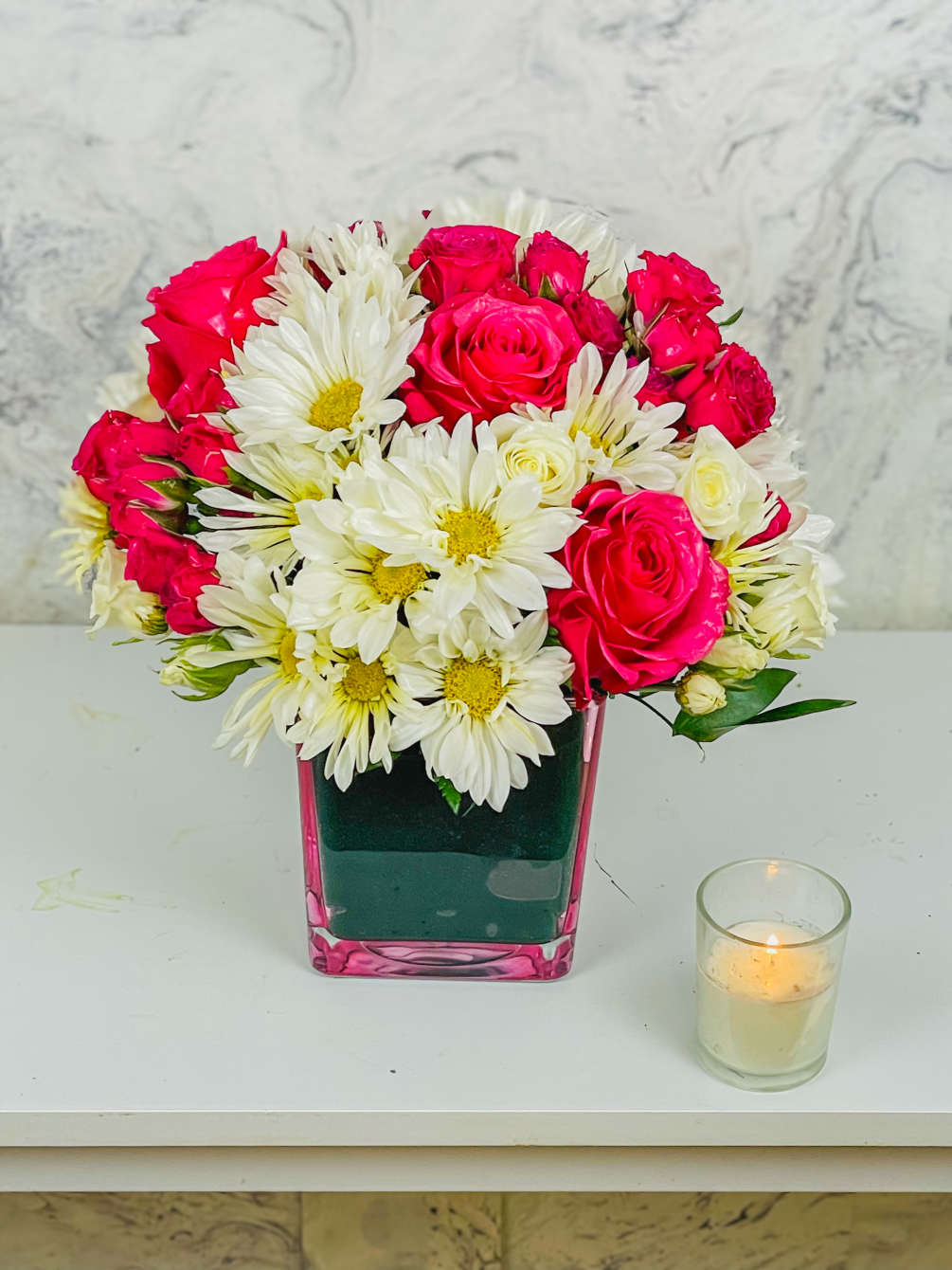 This arrangement contains spray daisies and spray roses. This is a great