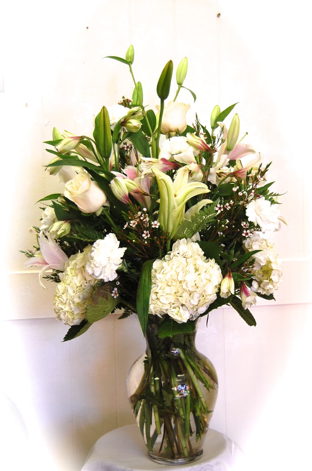 Siberian Lilys, White Hydrangeas White Roses, Wax Flower White Alstromeria arranged in