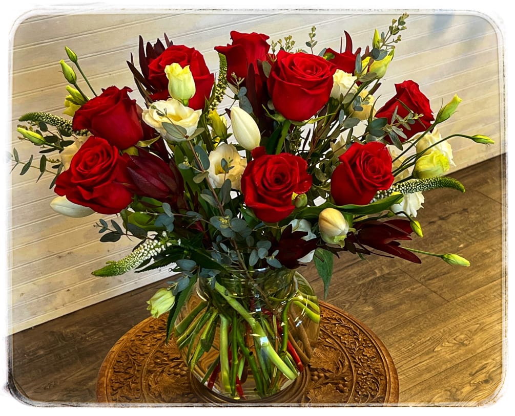 This stunning arrangement had a dozen red roses, veronica, lizzy, tulips and