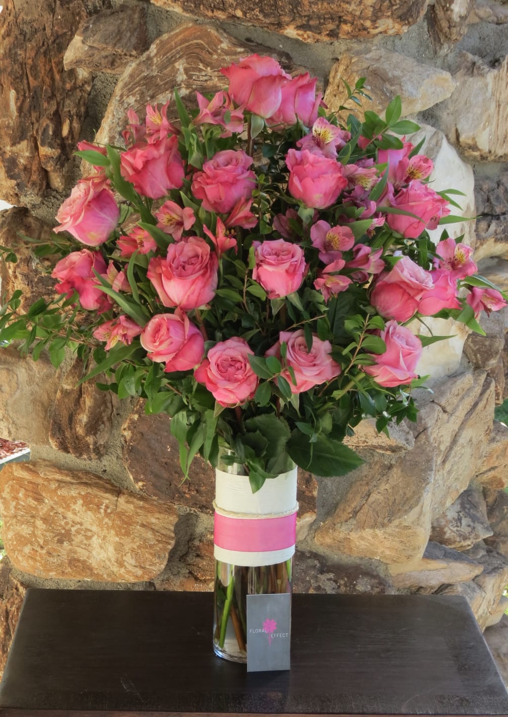 24 Roses arranged in a glass vase. Other colors available