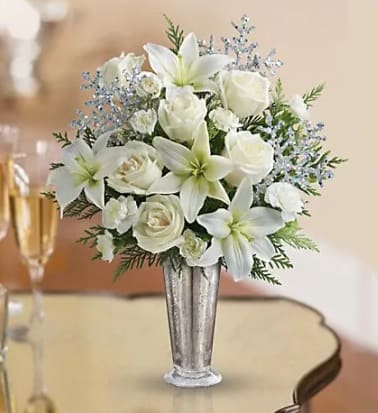 Winter Sparkle is Roses and Lilies in a Mercury Glass Vase.