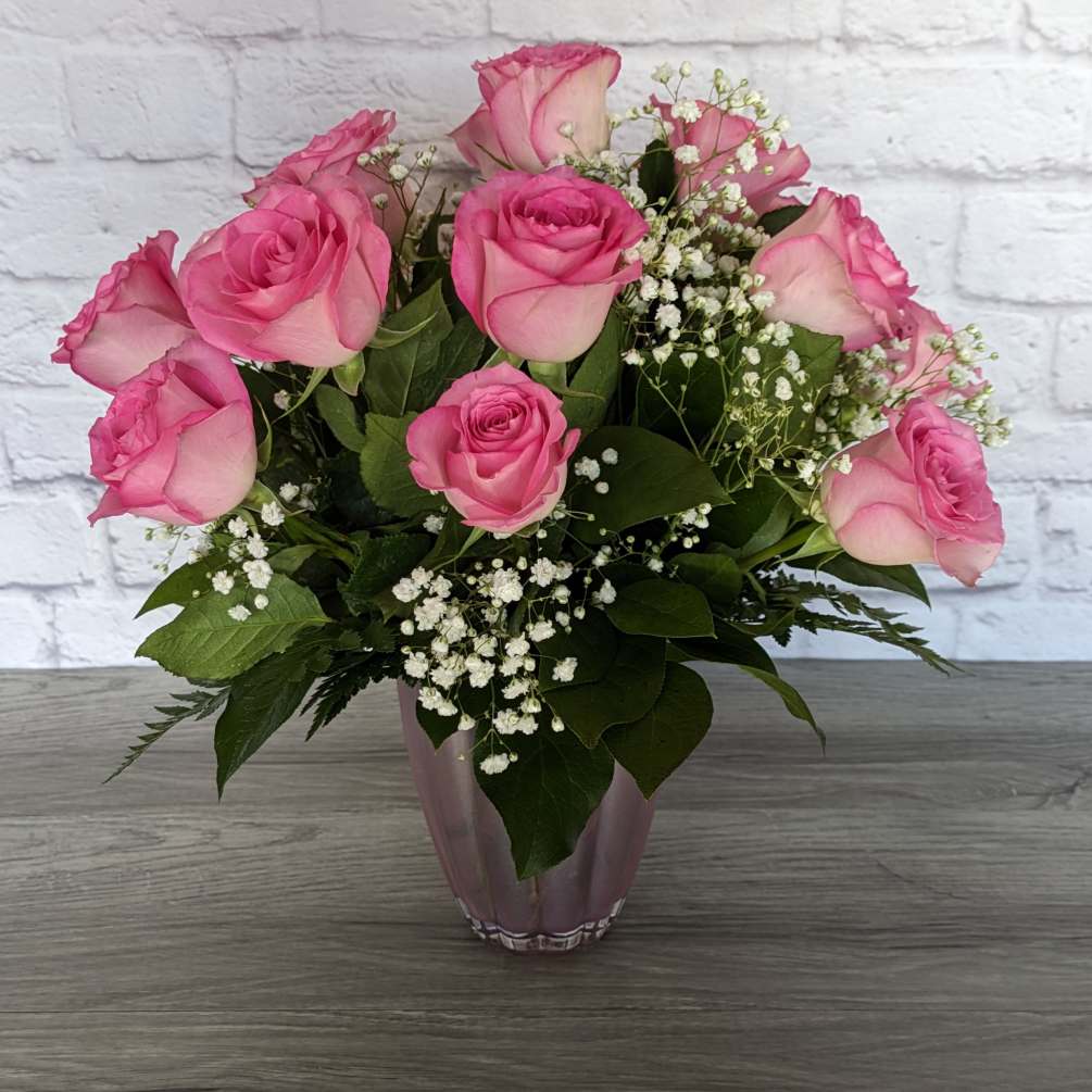 Refined Pink Roses uses shorter rose stems in a colored glass vase