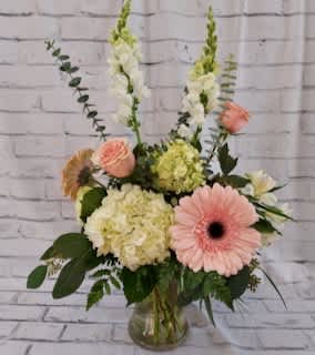 A sweet and simple vase accented with pastel hues of peach, blush