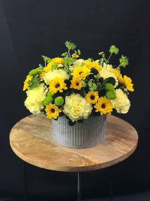 Shades of yellow and green breath life into this playful arrangement. 