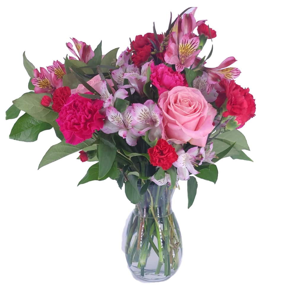 Blushing shades of pink blooms are nestled in lush greens to charm