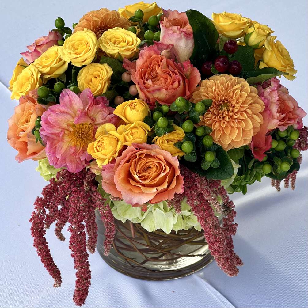 A cute, tabletop arrangement, consisting of vibrant, long lasting blooms such as