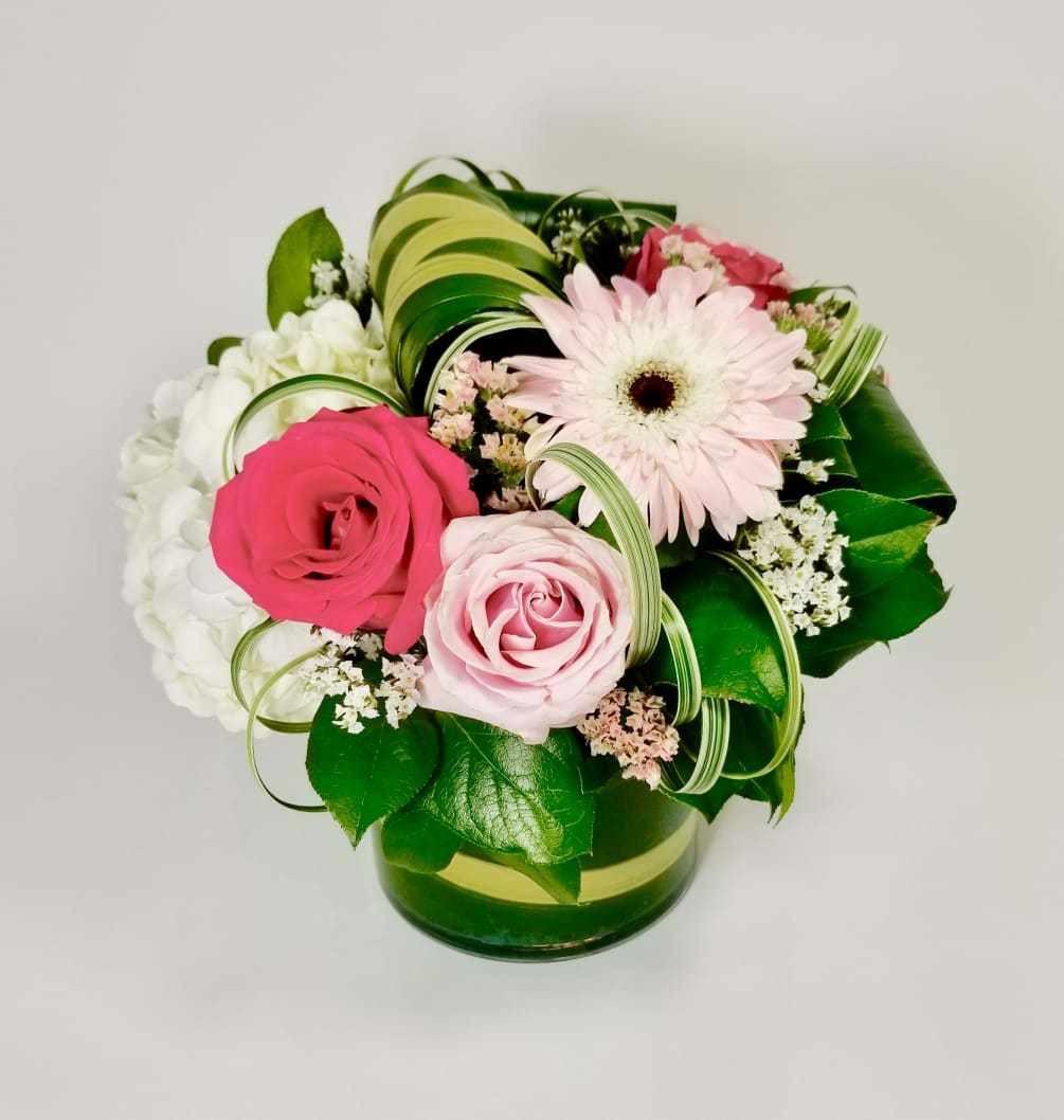Modern Arrangement of Premium Pink Roses, Gerberas, Hydreangea, Statice, Lily Grass, and