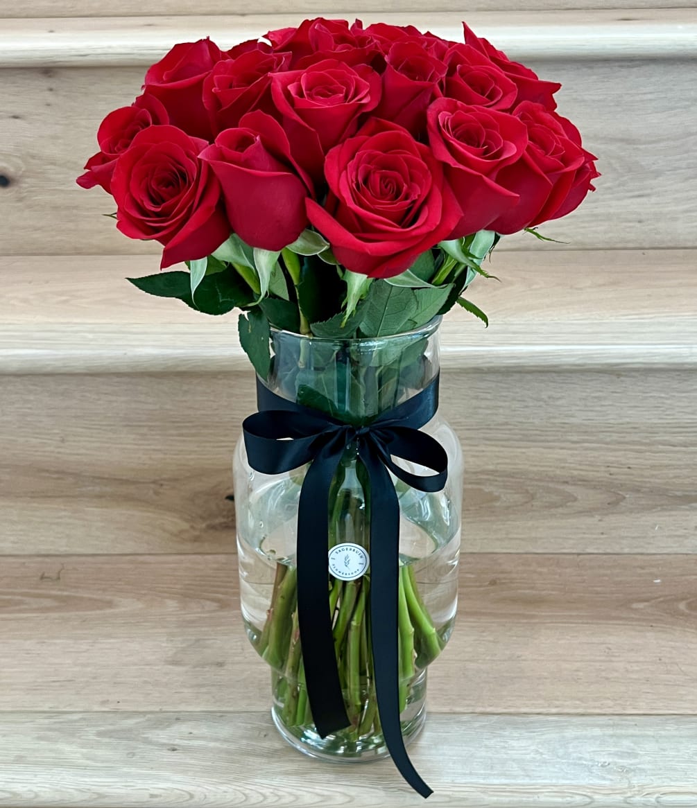 4 dozen premium long stem red roses in a premium glass vase
