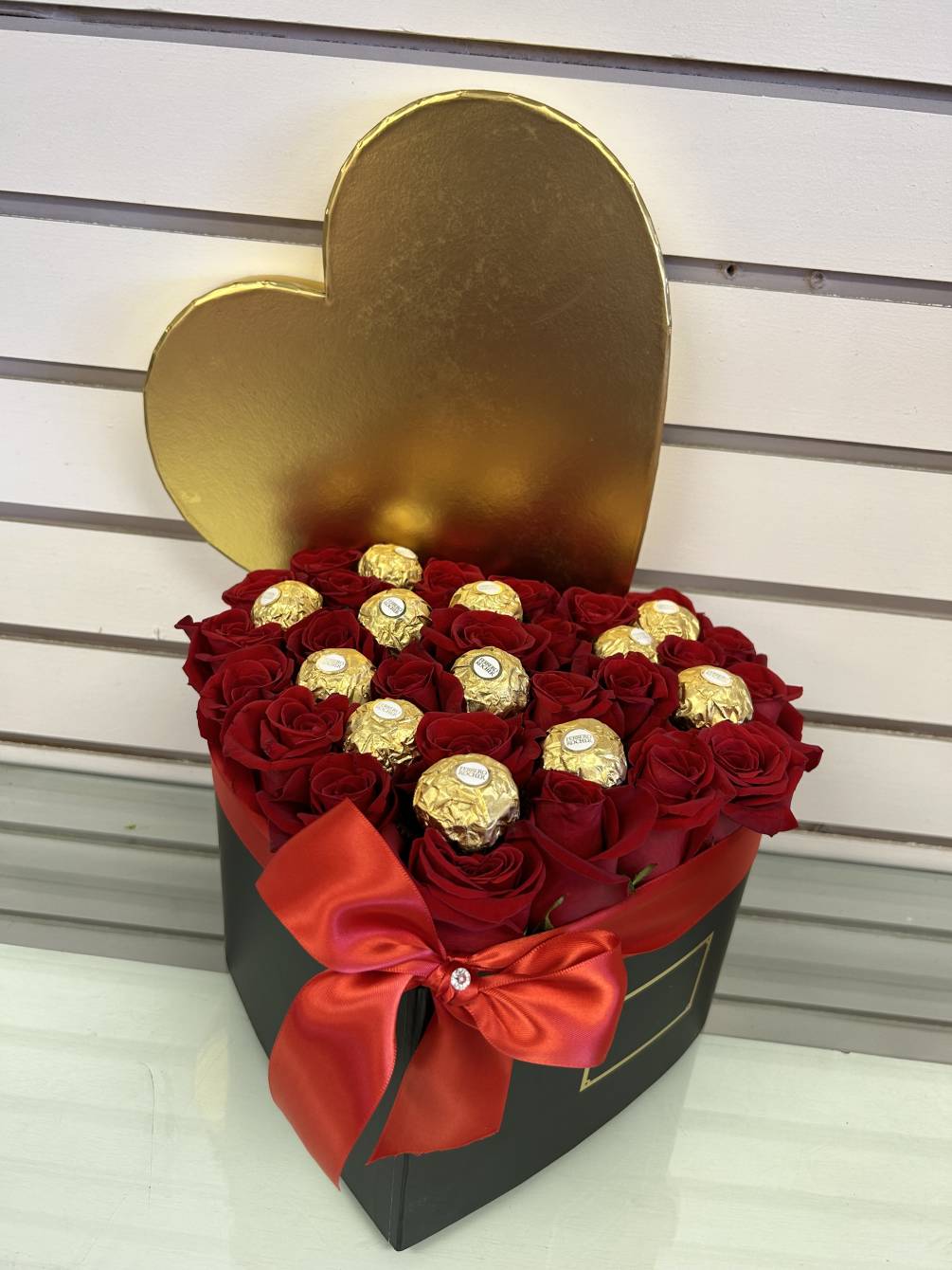 Our signature premium roses arranged in a heart-shaped box with chocolates.