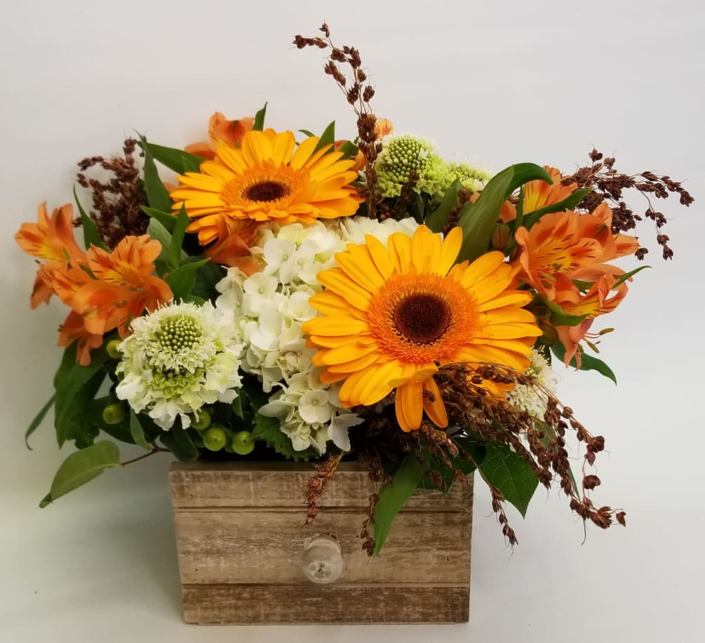 A box of blooms in a rustic drawer or wooden box in