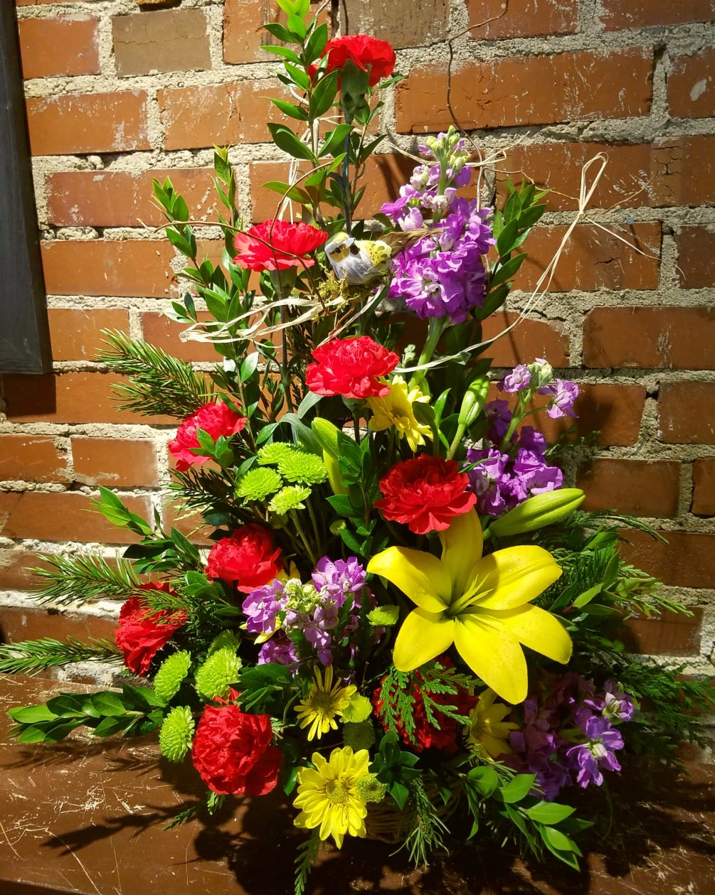 This arrangement is created by using our finest bright and colorful flowers.