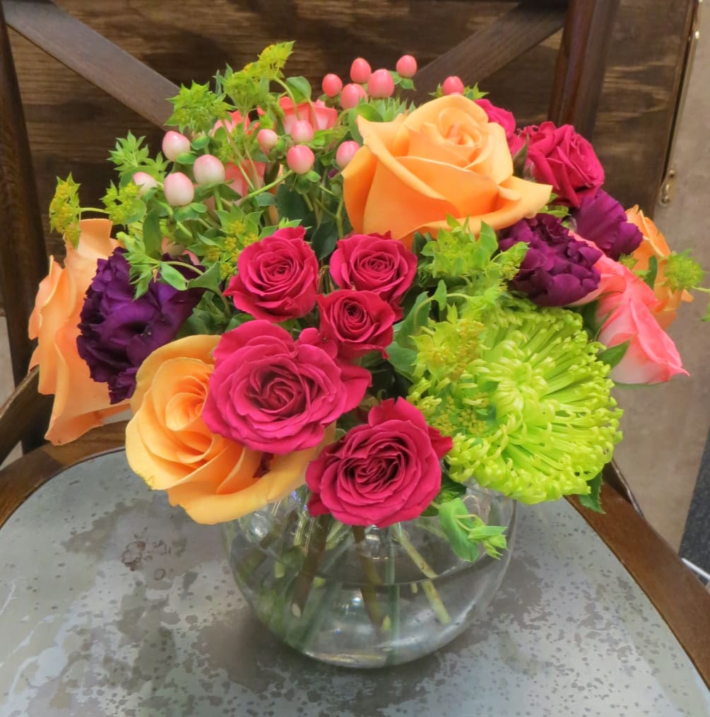 This bright and cheerful arrangement will make anyone smile. Roses, mums, and