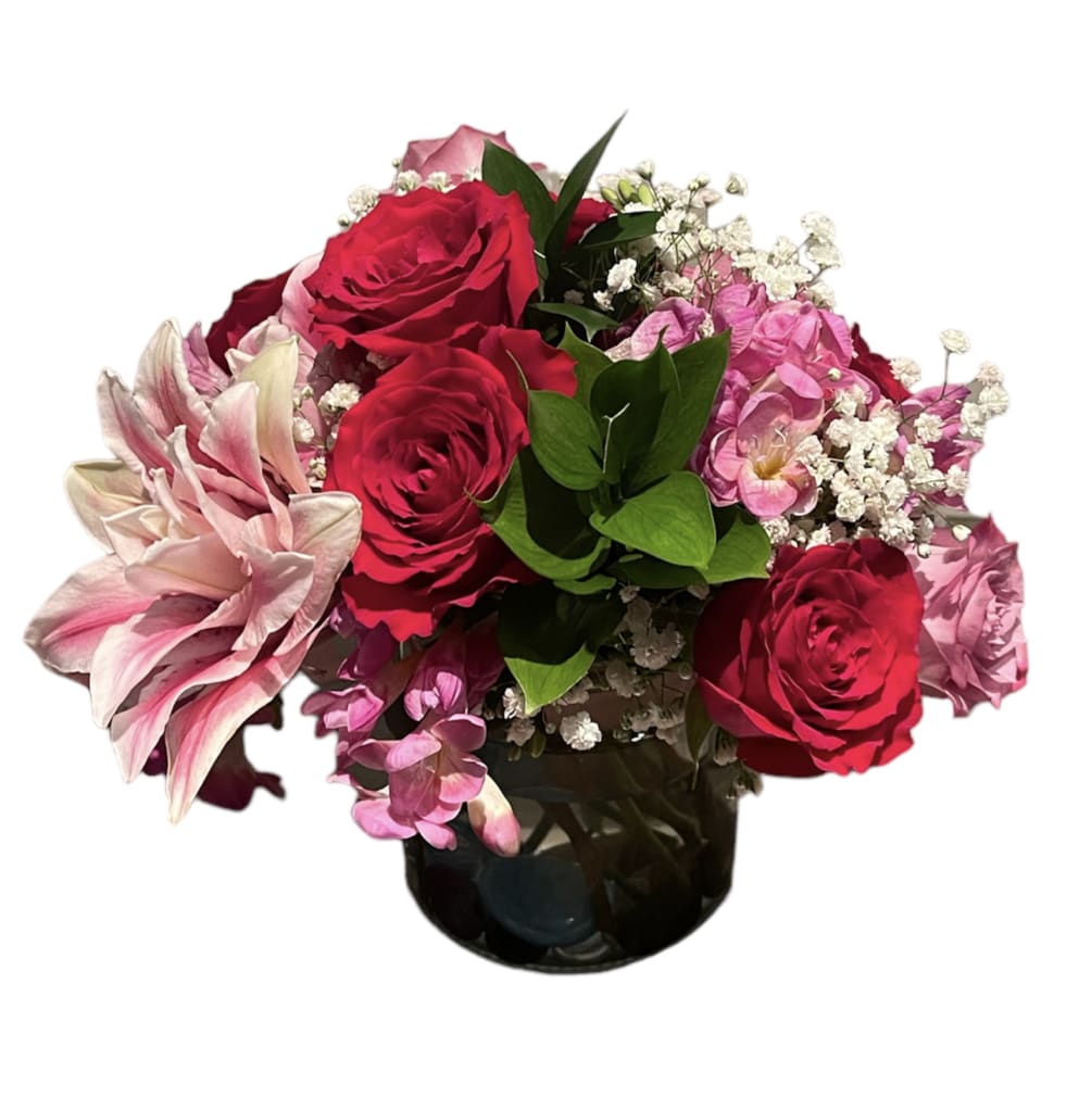 Exotic Beauty features  mini orchids with lilies, roses, baby&rsquo;s  breath