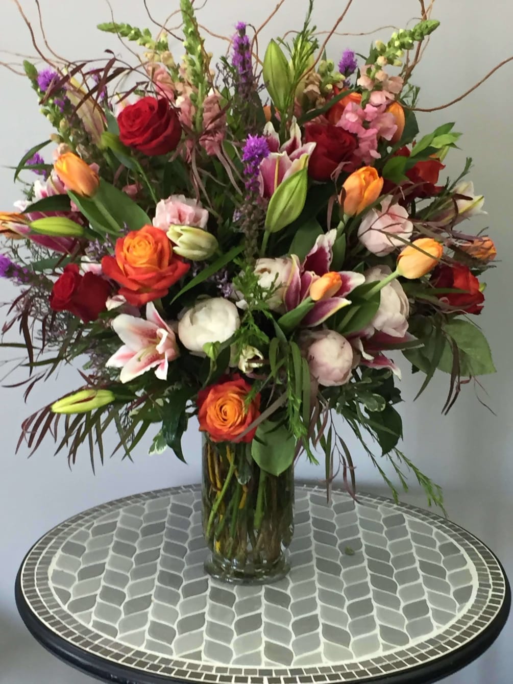 This beautiful arrangement is filled with oriental lilies, tulips, roses, liatris and