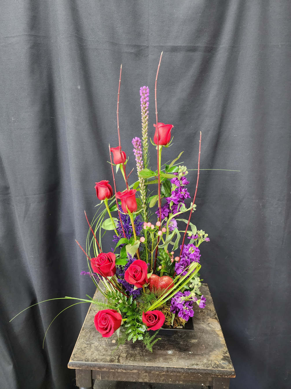 Organic, modern design with traditional red roses and purple accents. Show your