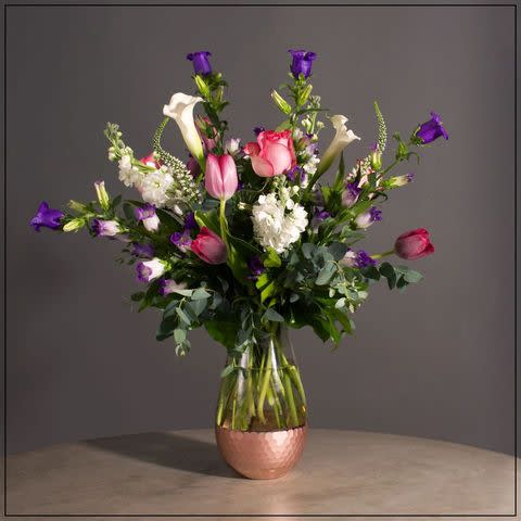 Capanula, Calla Lillies, Tulips, Stock and Veronica with Premium Greens in a