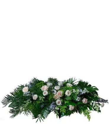 This elegant casket spray providing a peaceful remembrance features premium blooms of