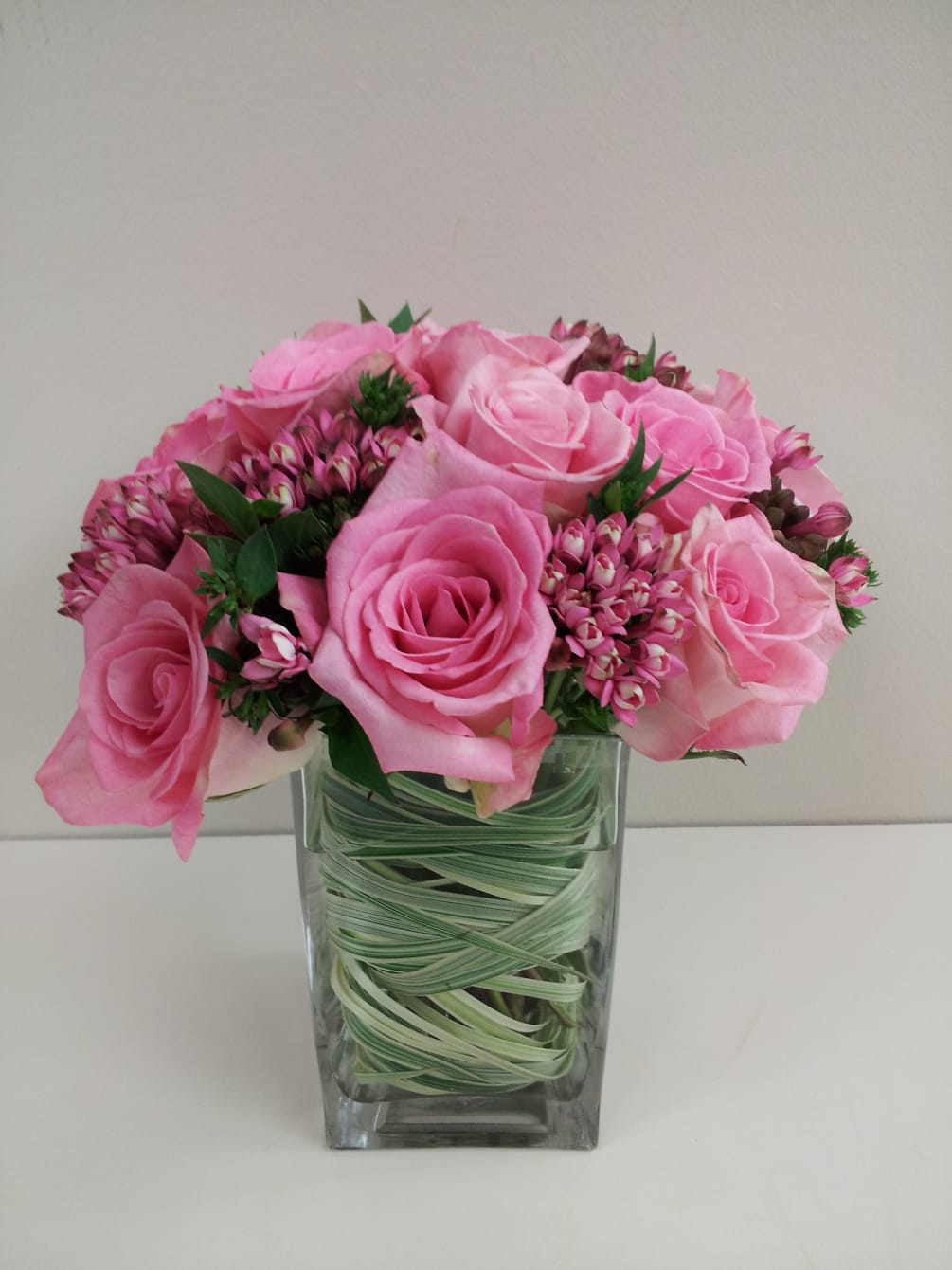 A sweet and charming arrangement featuring premium pink roses and complementary florals