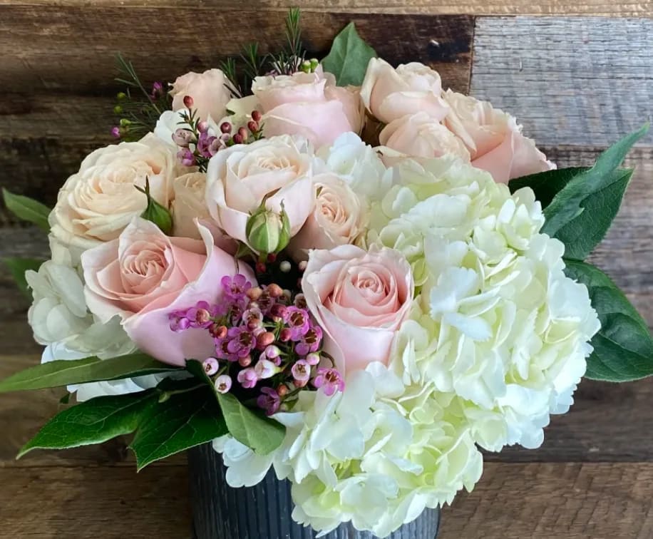 A sweet, romantic mix of soft blush pink roses and garden spray